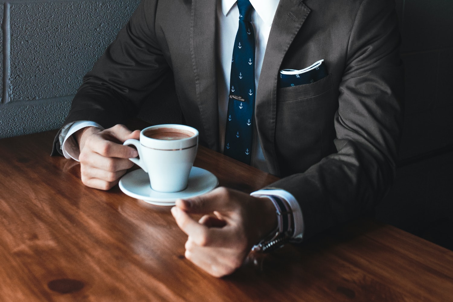 A businessman takes a break with a cup of coffee.
