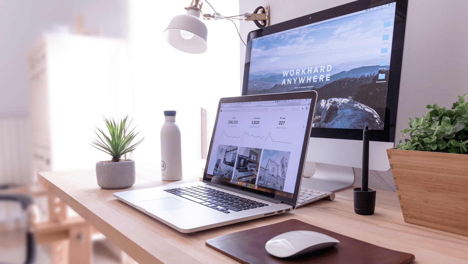 work anywhere from home home office desktop showing two computers- a laptop and a desktop computer