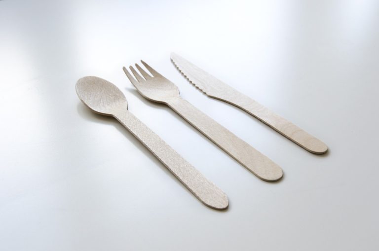 An Eco-friendly spoon, fork, and knife on a shiny clean table