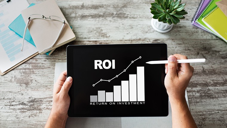 Tablet screen showing rising ROI chart graph