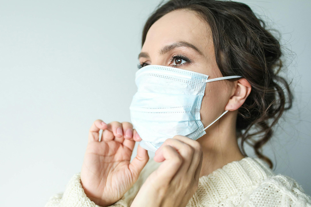 Lady adjusting face mask